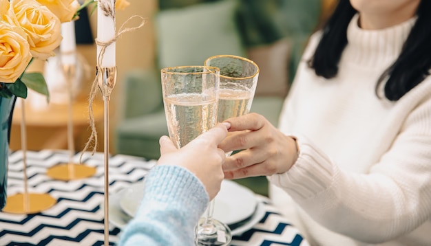 Closeup of glasses with champagne in female hands