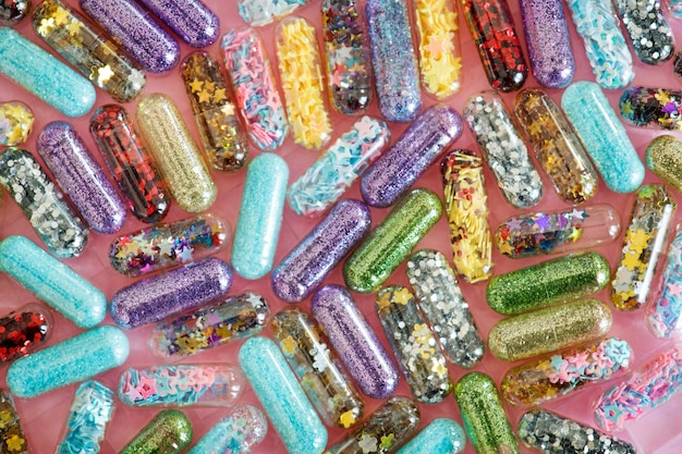 Closeup of glittery shimmery shiny pills capsule background