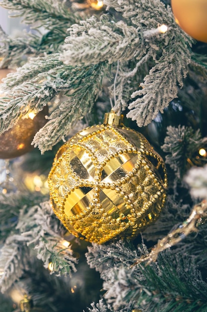 Free Photo closeup golden ball on a christmas tree closeup