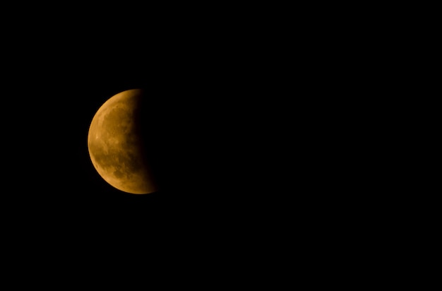 Free Photo closeup of a half moon against a dark sky