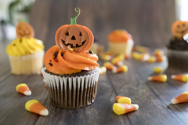 Closeup of Halloween cupcakes with colorful spooky toppings on the table