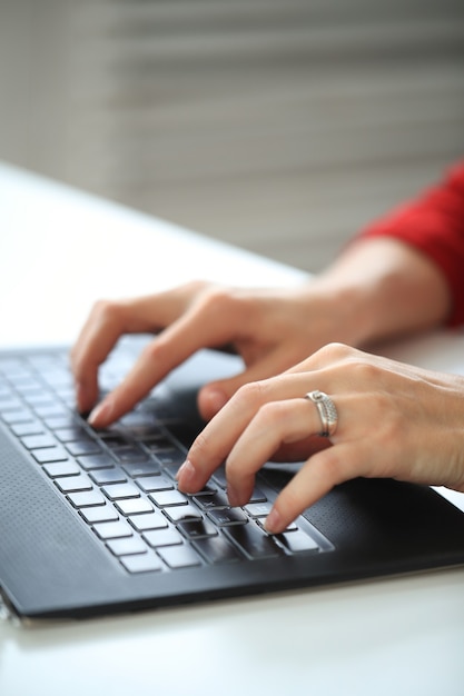 Closeup of hands writing with computer keyboard