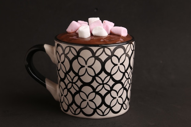 Free photo closeup of a hot chocolate drink with marshmallows on top with a black background