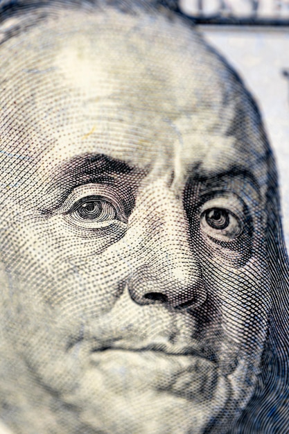 Closeup image of benjamin franklin on bill finance concept