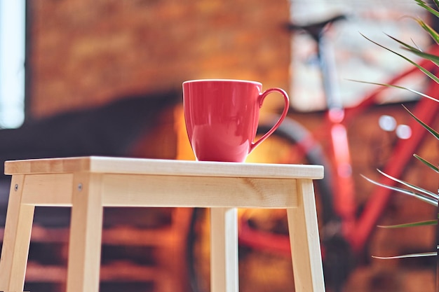 Free photo closeup image of red coffee cup on a table.