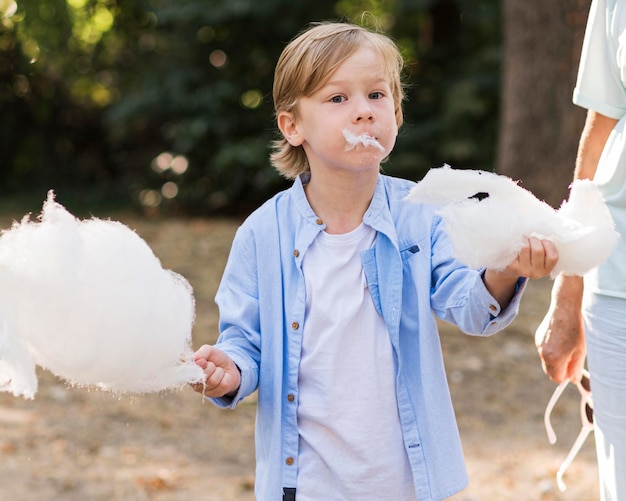 Free Photo closeup kid holding cotton candy