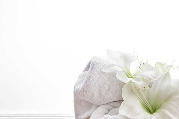 Free photo closeup lily flowers and a towel on a white background isolated