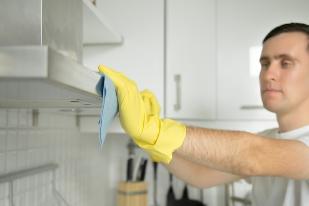 Free photo closeup of male hands in rubber gloves cleaning extractor hood