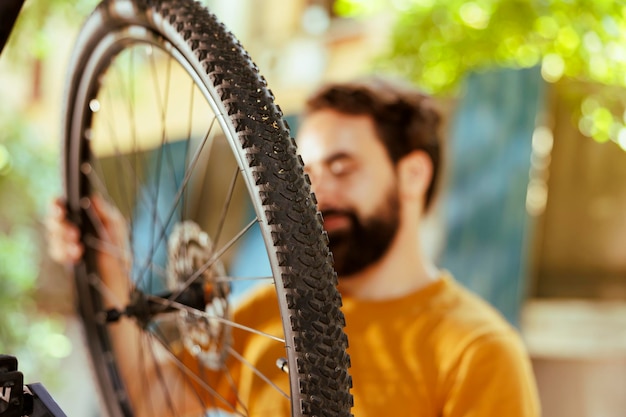 Free photo closeup of man adjusting bike tire