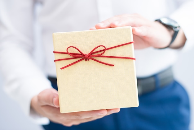 Closeup of man holding gift box