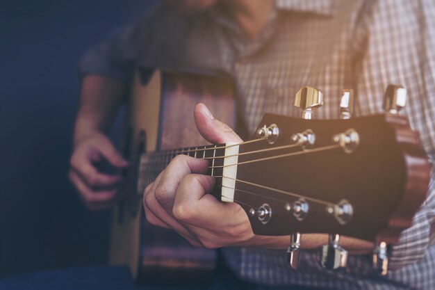 Closeup of man playing guitar