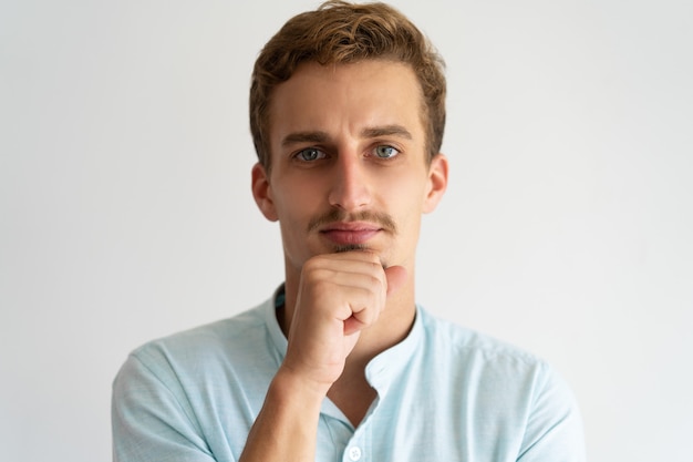 Free Photo closeup of pensive serious guy in white casual shirt. 