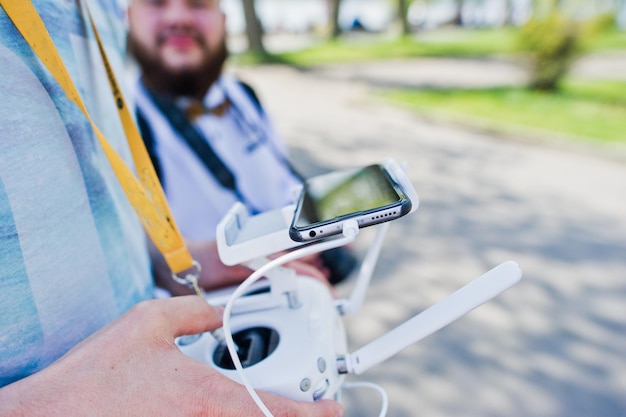 Free Photo closeup photo of male hands holding remote control of a drone