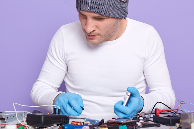 Free Photo closeup portrait of attentive well skilled electronic engineer doing repair