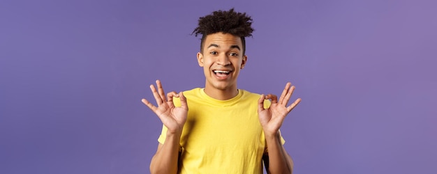 Closeup portrait of upbeat relaxed young hipster guy with dreads assuring all good everything be oka