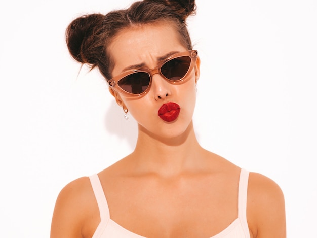 Closeup portrait of young beautiful sexy hipster woman with red lips in sunglasses.