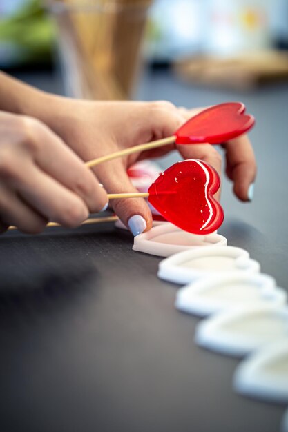 Closeup the process of making heartshaped lollipops