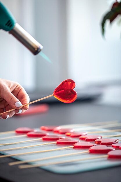 Closeup the process of making heartshaped lollipops