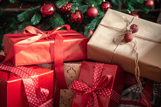 Closeup of red gift boxes near the christmas tree