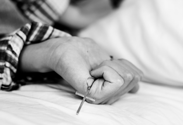 Closeup of a rosary in woman hand