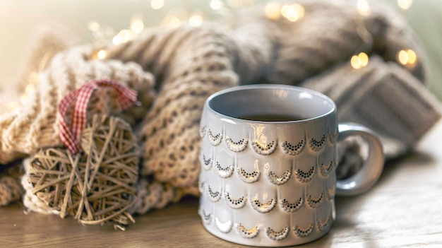 Free Photo closeup shiny gray cup on a blurred background with a knitted element