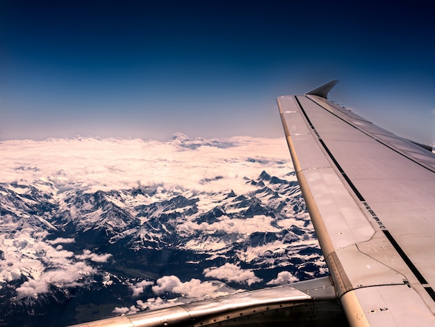 Free photo closeup shot of an airplane wing and mountains