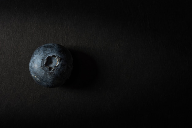 Closeup shot of blueberry on a black background