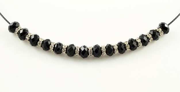 Free Photo closeup shot of a bracelet with black shiny beads isolated on a white background in studio