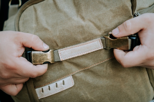 Free Photo closeup shot of buckle and strap of a brown canvas camera utility bag