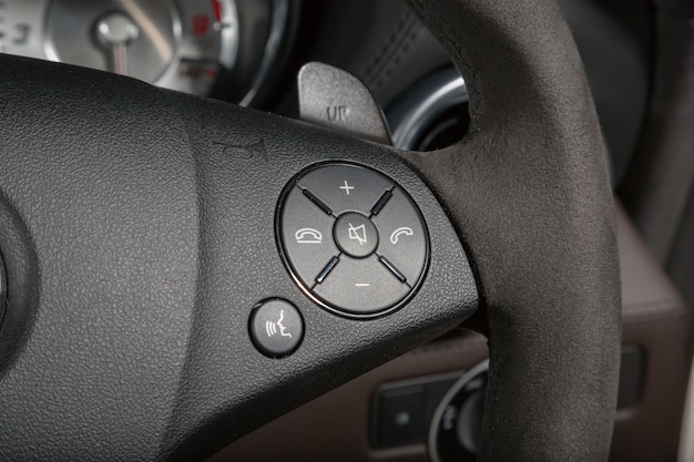 Closeup shot of call buttons on the steering wheel of a modern car