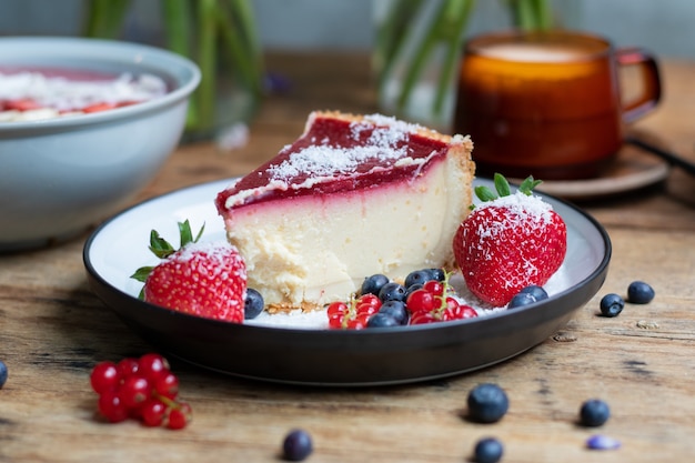 Closeup shot of cheesecake with jelly decorated with strawberries and berries