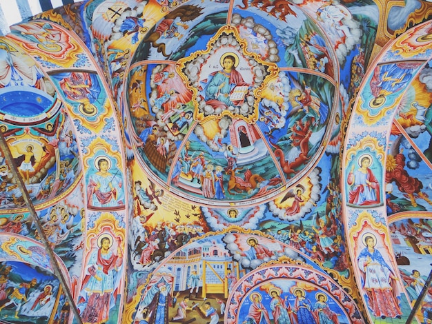 Closeup shot of Christian religious imagery on the ceiling of church walls