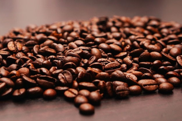 Closeup shot of coffee beans on a wooden table