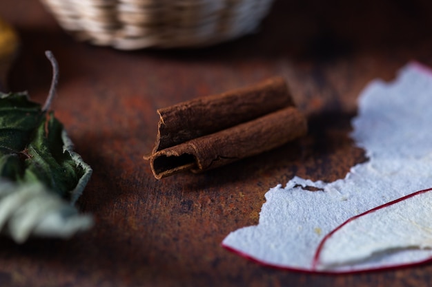 Closeup shot of dried autumn leaves on a dark brown table