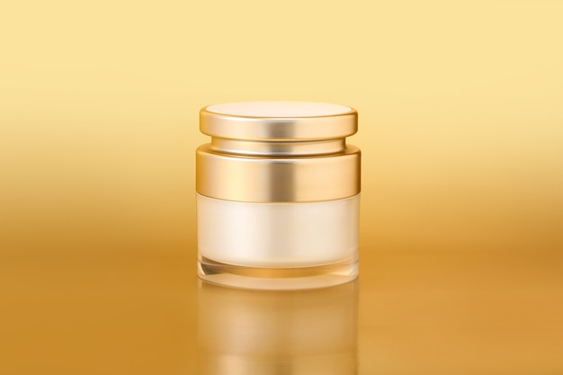 Closeup shot of an elegant gold skincare container on a gold background