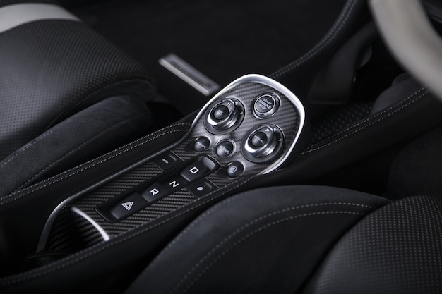 Closeup shot of the engine start buttons inside a modern sport car