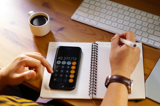 Closeup shot of an entrepreneur working from home and doing calculations