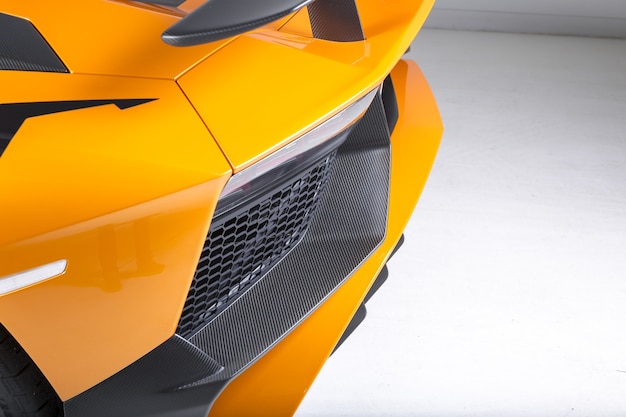 Closeup shot of the exterior details of a modern yellow sport car