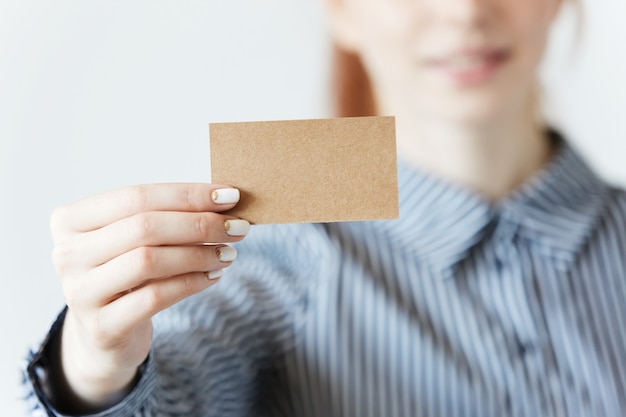 Free photo closeup shot of female hands holding a blank business card