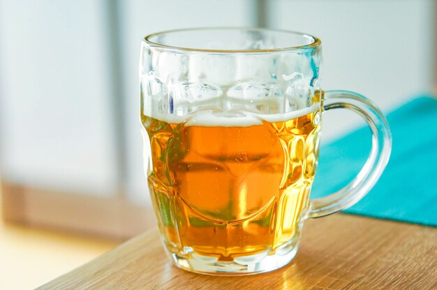 Closeup shot of a glass of beer on a wooden table