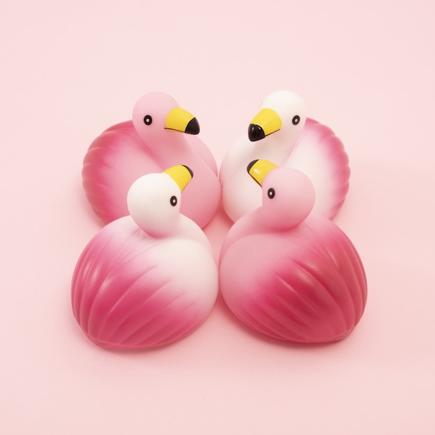 Free photo closeup shot of a group of identical rubber flamingos facing each other