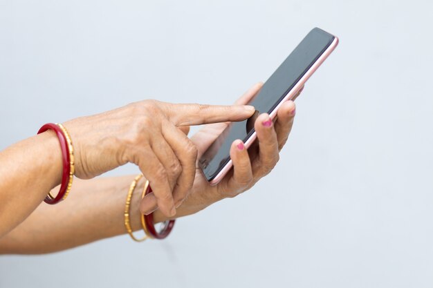 Closeup shot of the hands of a person texting with the phone on a blurry