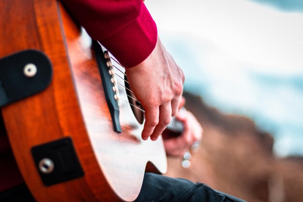 Closeup shot of hands playing acoustic guitar