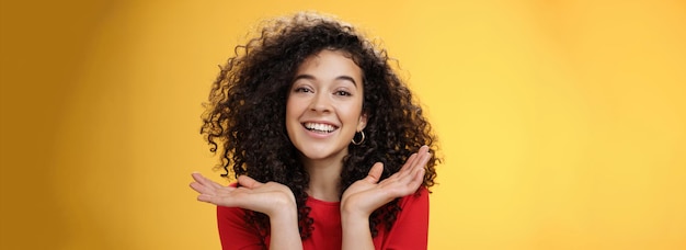 Free photo closeup shot of happy kind and tender pretty caucasian female student with curly hair and perfect sk