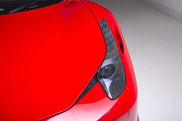 Free photo closeup shot of the headlights of a modern red car