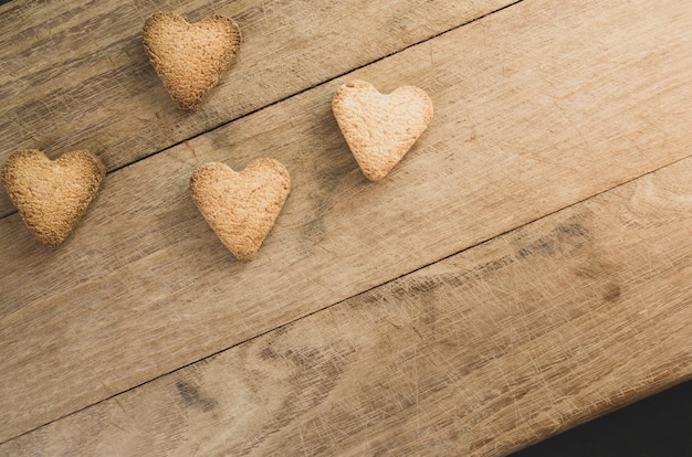 Free photo closeup shot of hearth shaped cookies on wooden background