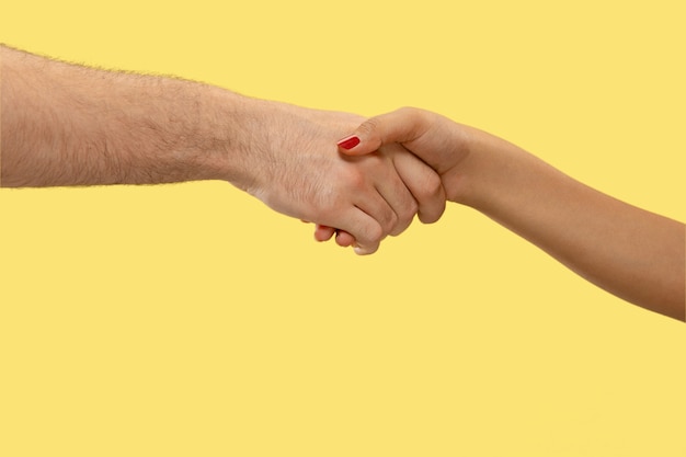 Closeup shot of human holding hands isolated. Concept of human relations, friendship, partnership. Copyspace.