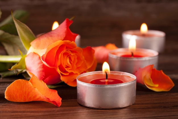 Closeup shot of lit red Christmas candles on a wooden surface