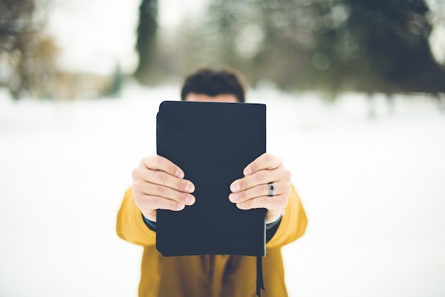 Free Photo closeup shot of a male holding the bible