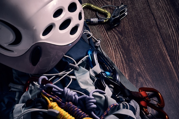 Free photo closeup shot of many colorful climbing carabiners and knots on a wooden surface